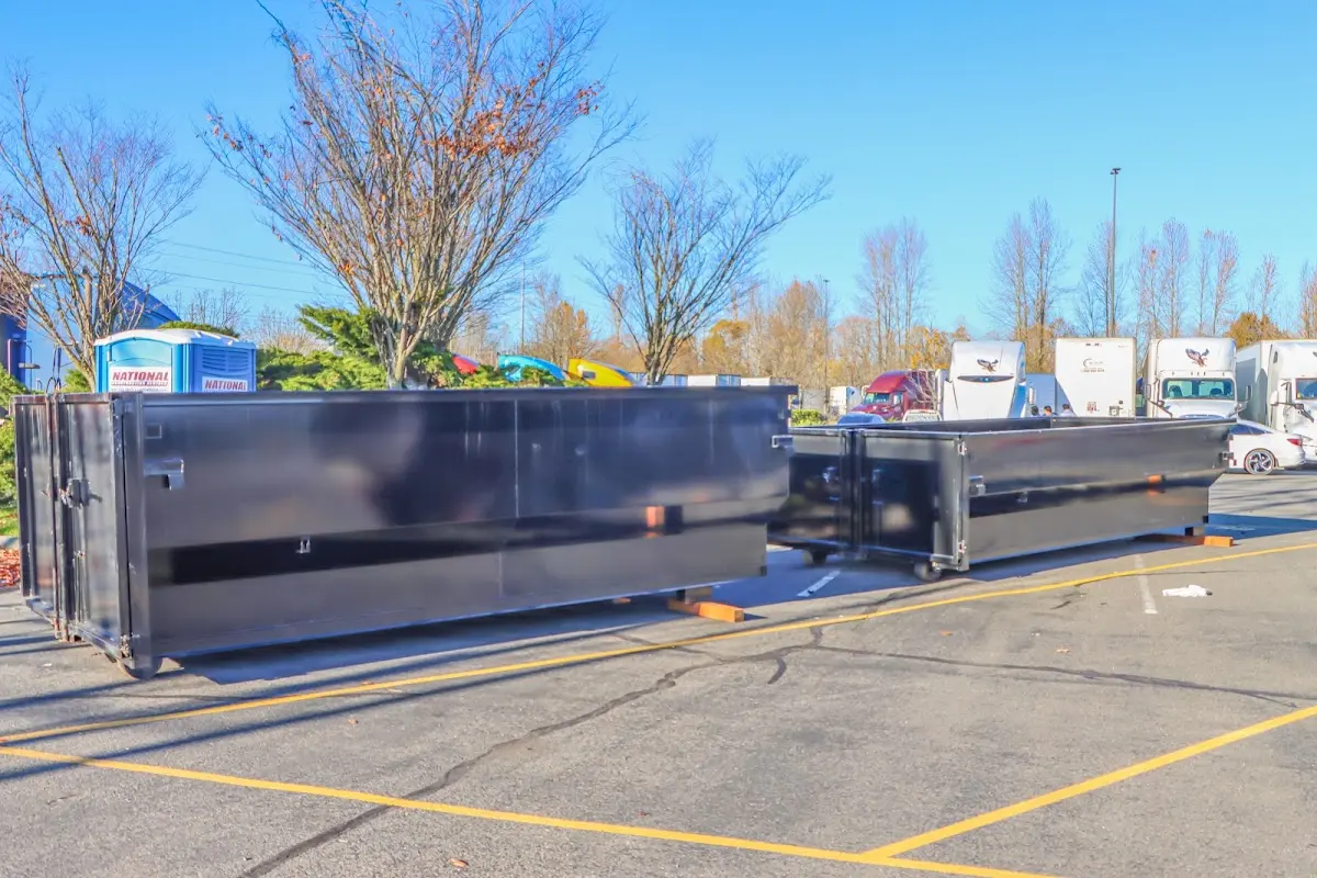 Professional dumpster rental service with roll-off container on residential driveway in Bangor Base